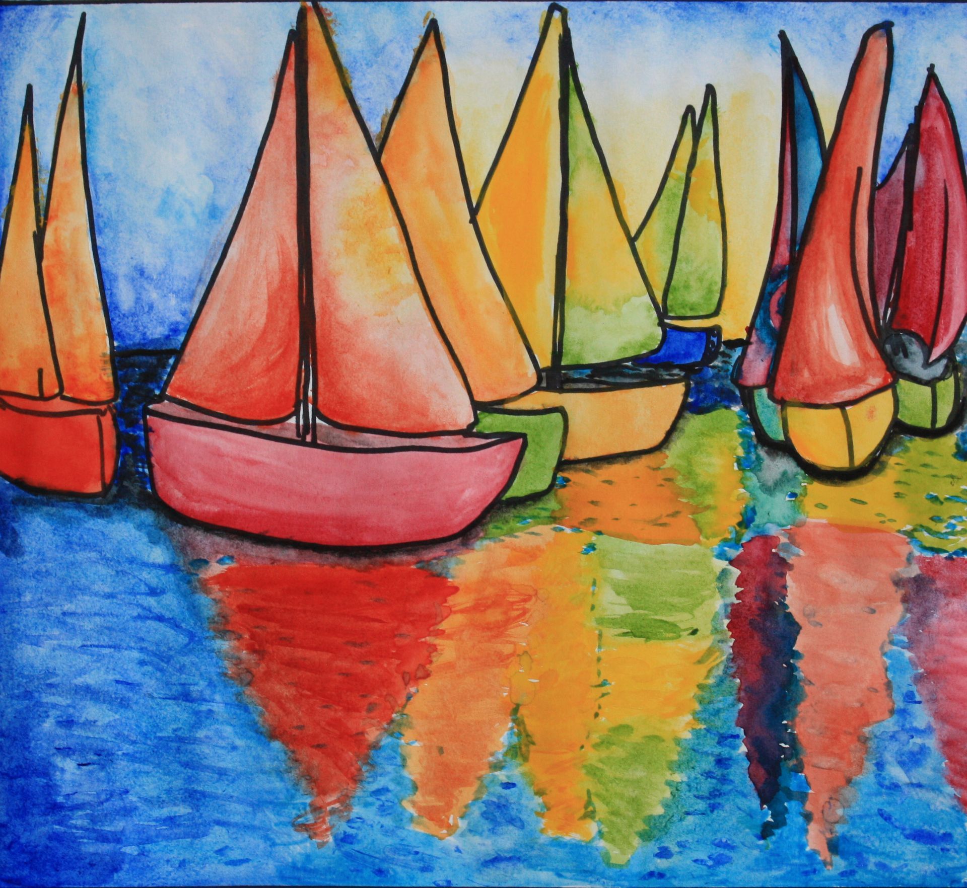 Colorful sailboats with red, orange, and yellow sails floating on blue water, their reflections shimmering.