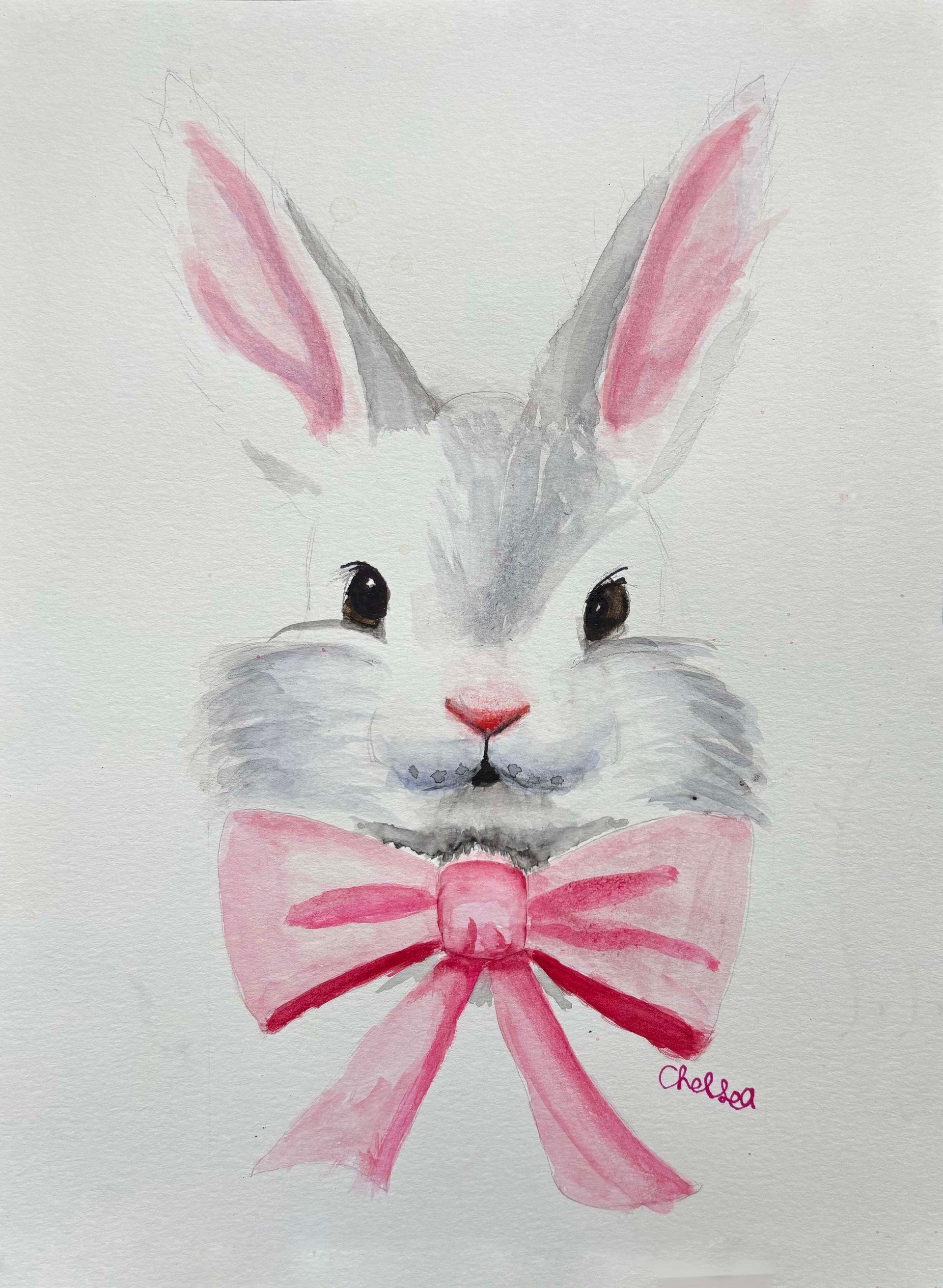 White bunny face with pink ears and a pink ribbon bow on a light background
