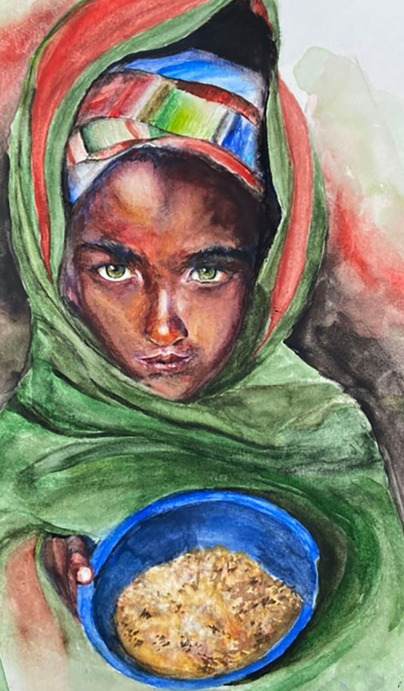 Child in a green shawl holds a blue bowl of grain, looking directly at the viewer.