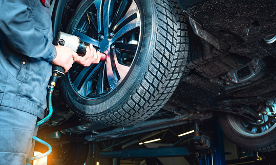 Mechanic handshaking customer in front of hood of vehicle | Finger Lakes Automotive & Marine
