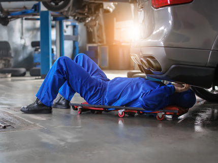 Mechanic grabbing tire from rack of tires | Finger Lakes Automotive & Marine