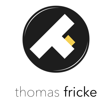 Ein Logo für Thomas Fricke mit einem „at“ im Kreis