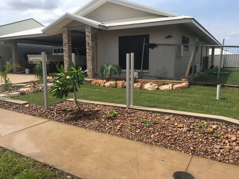 A House with A Fence and A Sidewalk in Front of It — Green Vision NT in Lee Point, NT