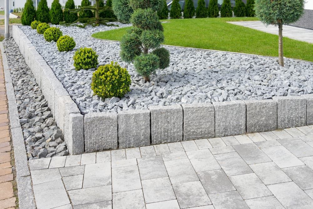 A Brick Walkway Leading to A Garden Filled with Rocks and Trees — Green Vision NT in Virginia, NT