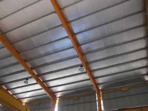 The ceiling of a building with a lot of lights hanging from it
