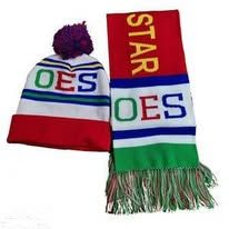 Red-and-white knit hat and scarf with purple pom-pom and green fringe, both reading “OES.”