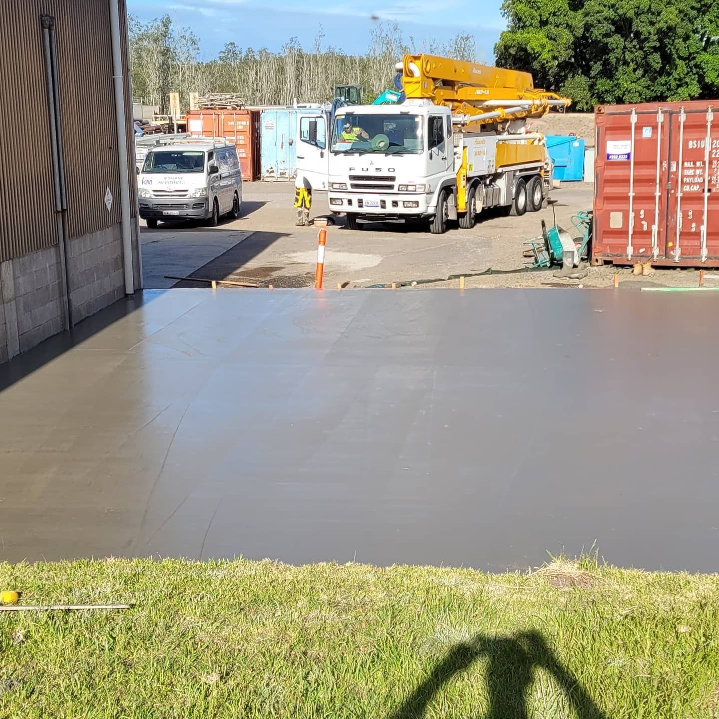 A Truck With A Crane On The Back Is Parked Behind Wet Concrete — Dave Smith Concrete in Lemon Tree Passage, NSW