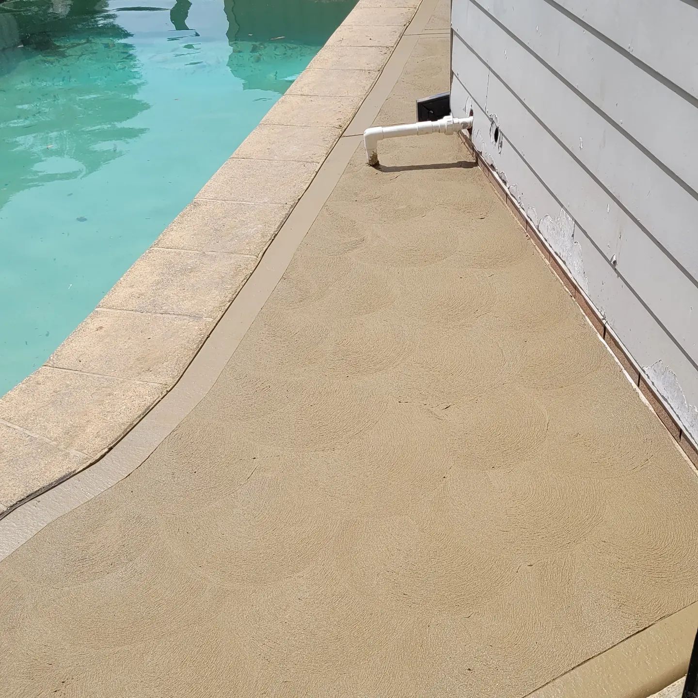 Blue Swimming Pool With Freshly Pour Concreting With Texture — Dave Smith Concrete in Salt Ash, NSW