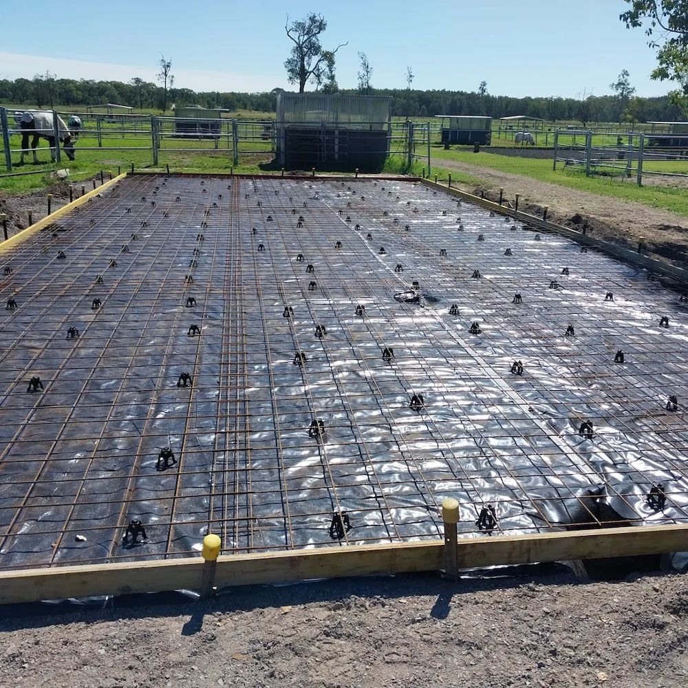 A Concrete Foundation Is Being Built In A Field — Dave Smith Concrete in Salt Ash, NSW