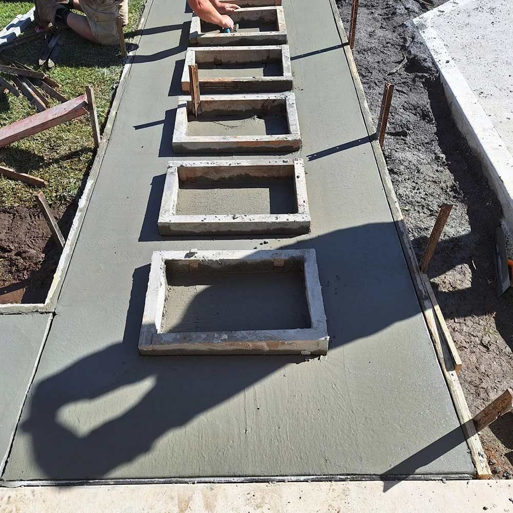 A Row of Concrete Blocks Are Lined Up on a Sidewalk — Dave Smith Concrete in Salt Ash, NSW