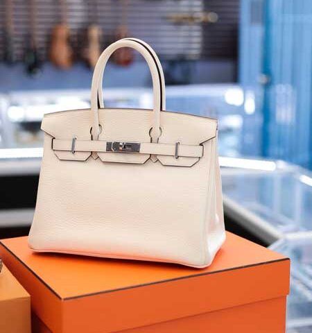 White handbag on an orange box in a store display