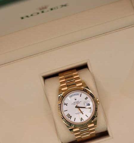 Gold wristwatch with white face in a presentation box