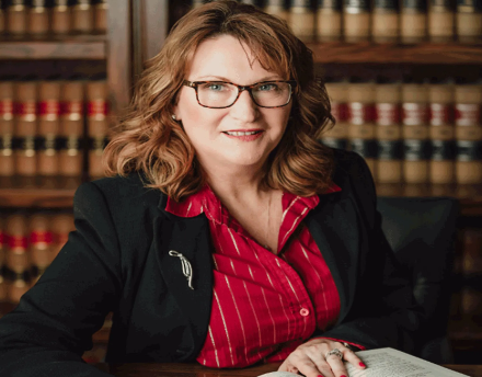 Female Lawyer Standing With Hands Folded — Lincoln, NE — McCord & Burns