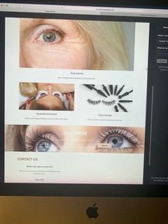 Website shown on an iMac screen with eye photos and contact/contact-us sections