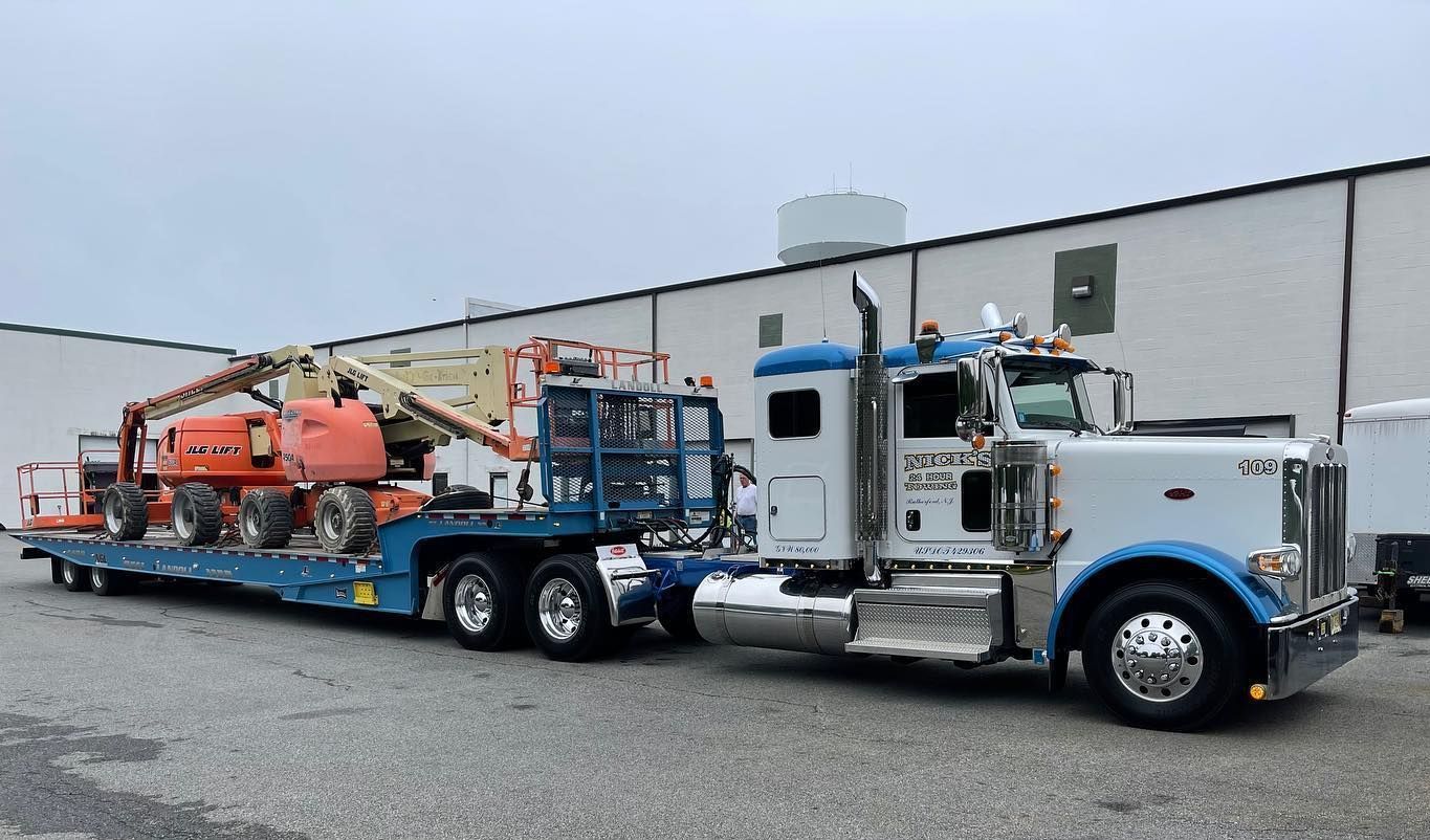 Nick’s Towing in Rutherford NJ hauling boom lifts—heavy-duty transport in Bergen County and beyond.