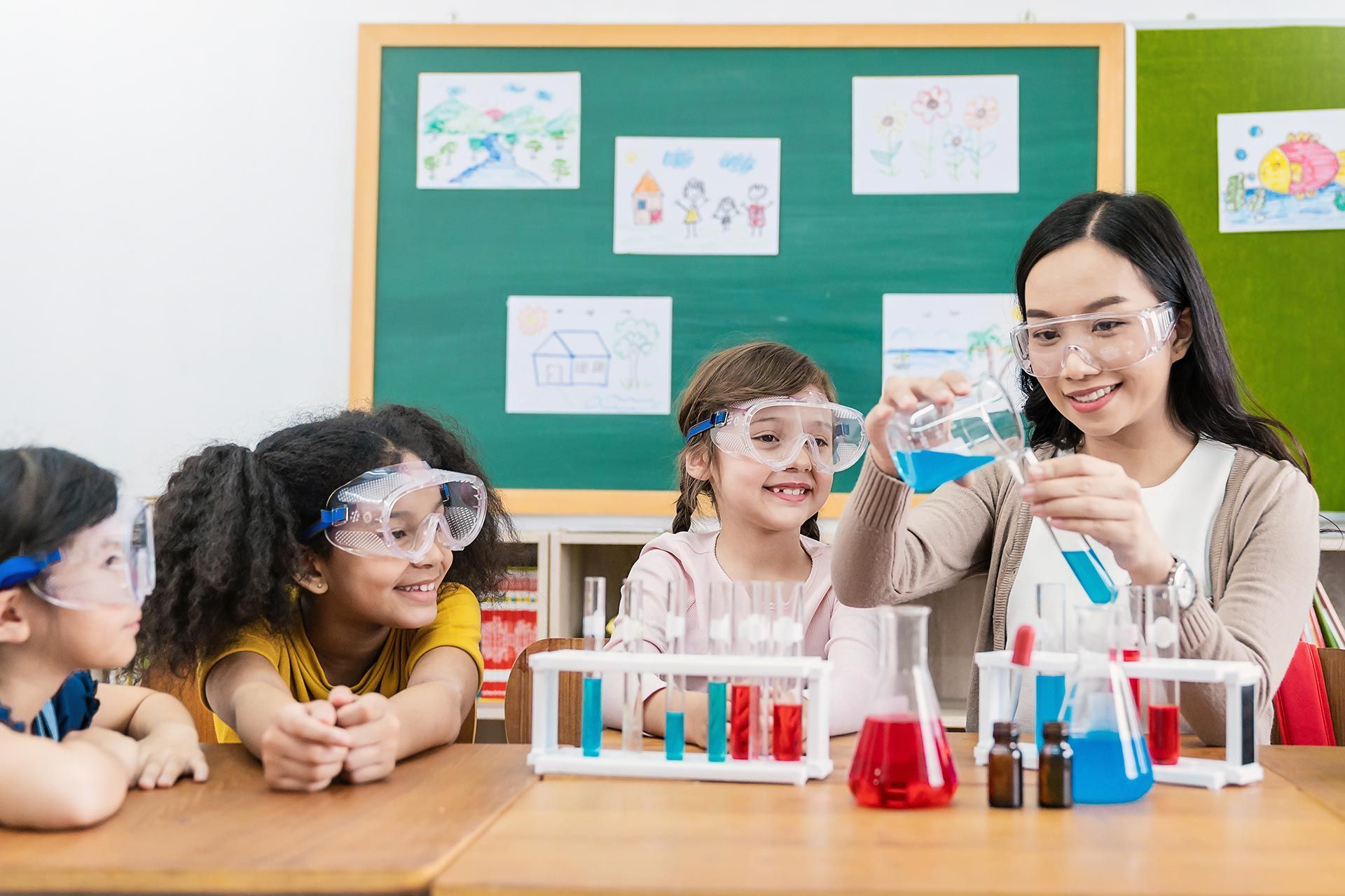 A teacher is teaching science to a group of kids. A teacher is teaching science to a group of kids.