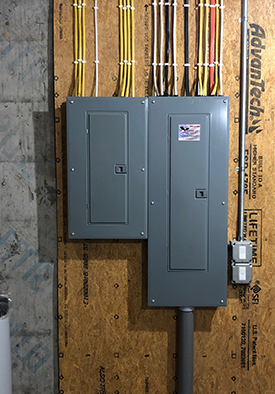 An electrical box with a lot of wires coming out of it.