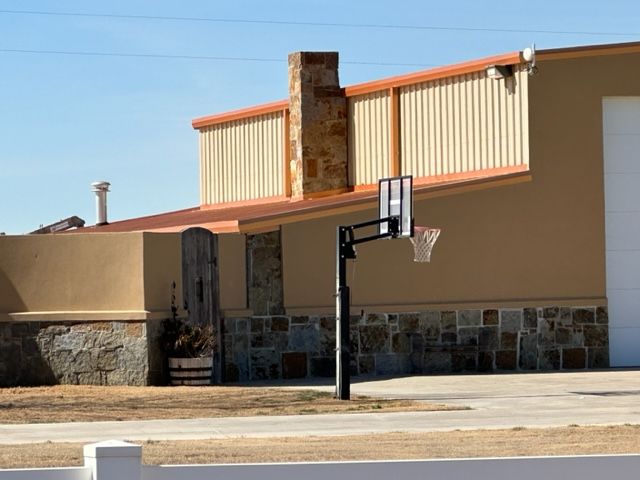A basketball hoop is in front of a house
