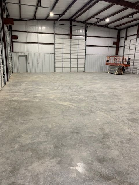 A large empty warehouse with a concrete floor