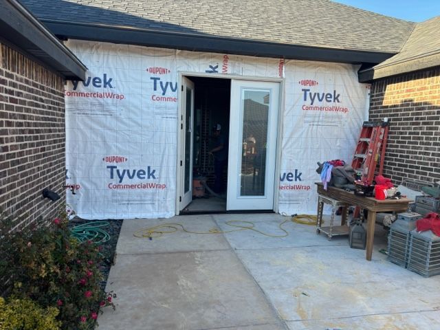 A house with a sliding glass door is being remodeled.