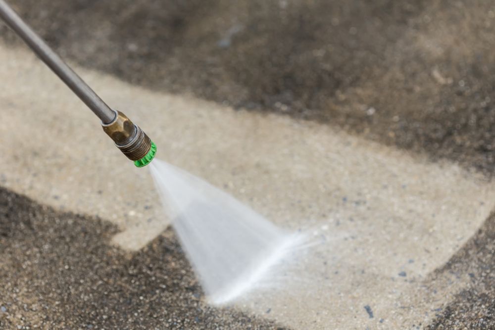 Pressure Washer Spraying Water Onto Concrete, Cleaning a Dirty Surface — Ericson Constructions in Mareeba, QLD