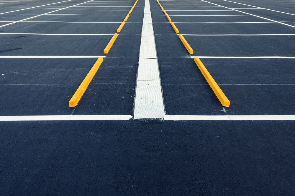 Empty Asphalt Parking Lot With White and Yellow Painted Lines — Ericson Constructions in Mareeba, QLD