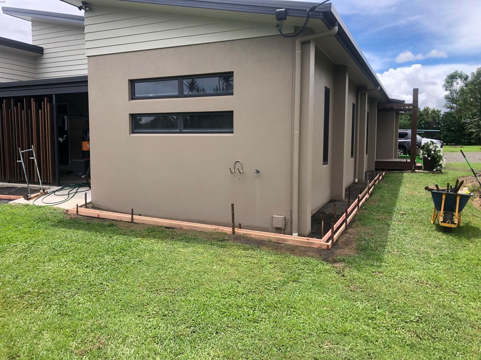 Outdoor living space with sectional sofa, fireplace, and bar — Ericson Constructions in Mareeba, QLD