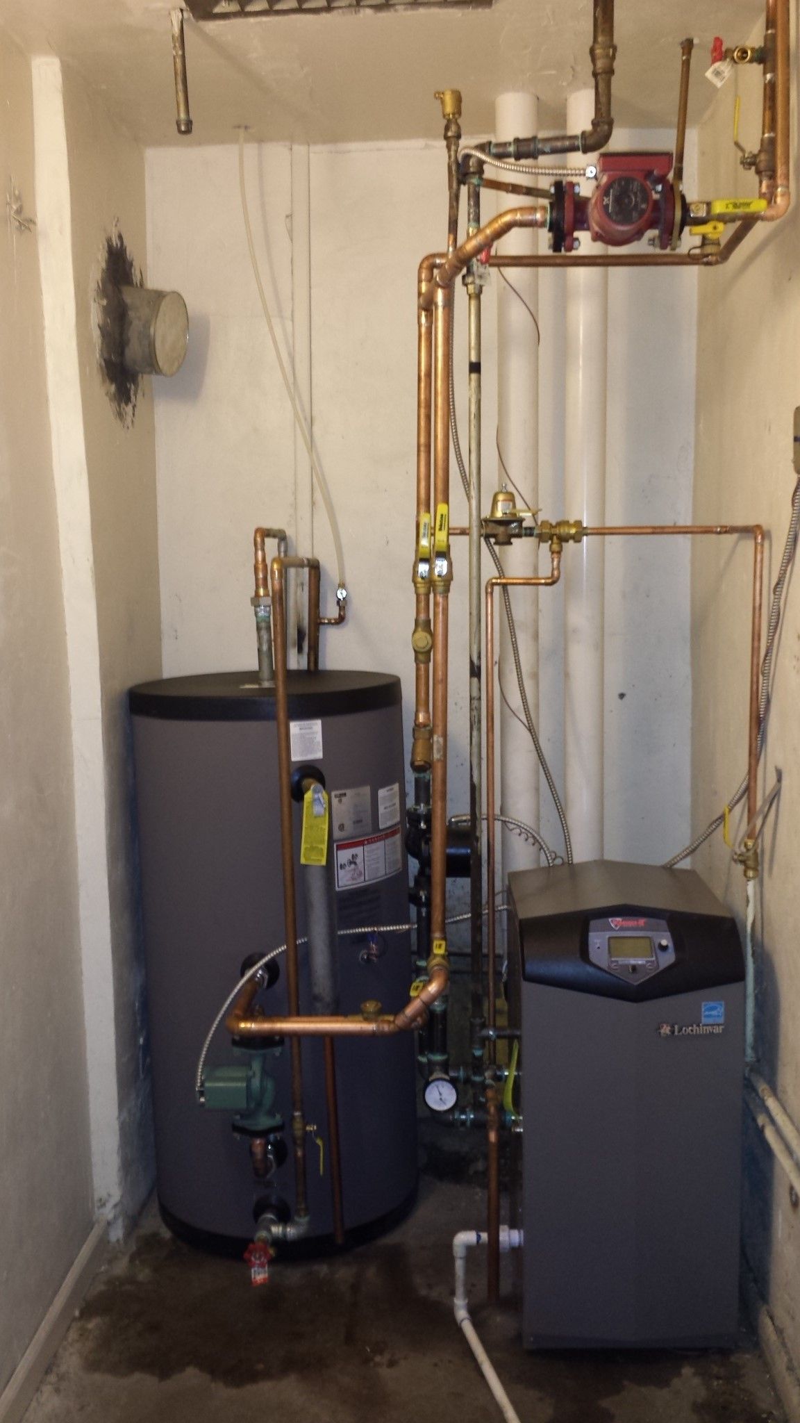 a room with a water heater and a gas boiler .