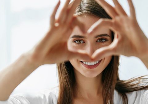 woman making a heart with hand