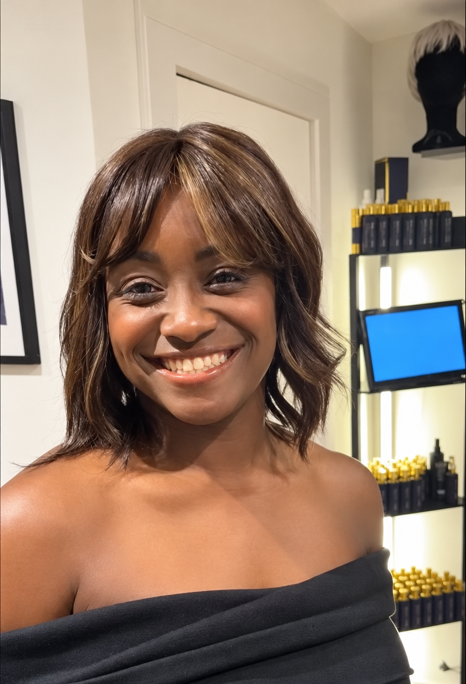 Natural-looking shoulder-length brunette wig with soft waves and a fringe at The Roche Hair Experience in Stafford.