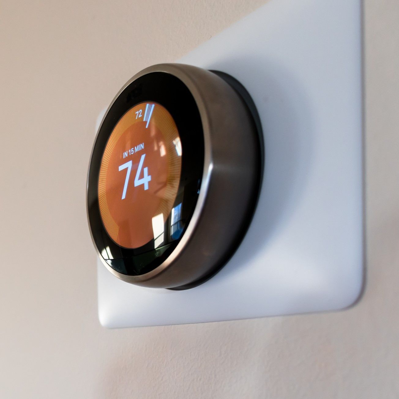 A thermostat that has the number 74 on it A thermostat that has the number 74 on it