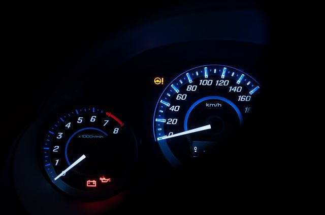 A close up of a car 's speedometer and tachometer