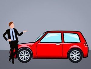 A man in a suit and tie is standing next to a red car.