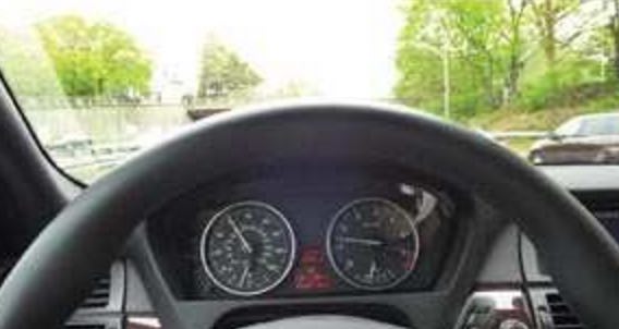 A close up of a steering wheel and dashboard of a car.