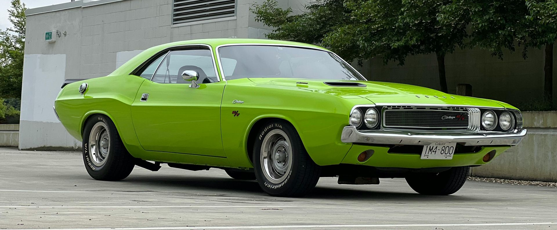 Bright green classic muscle car parked outdoors on a street