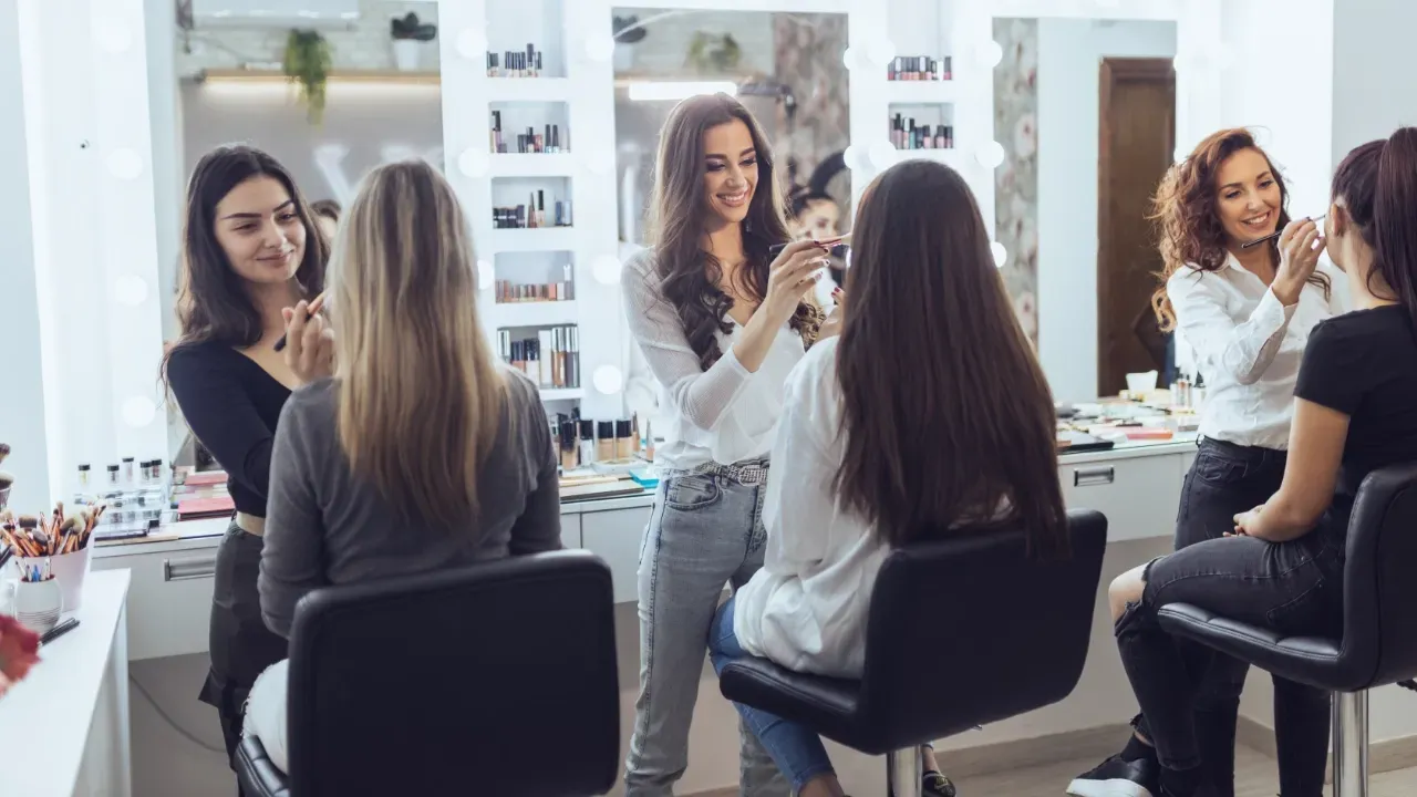 young women getting make up done in a beauty salon