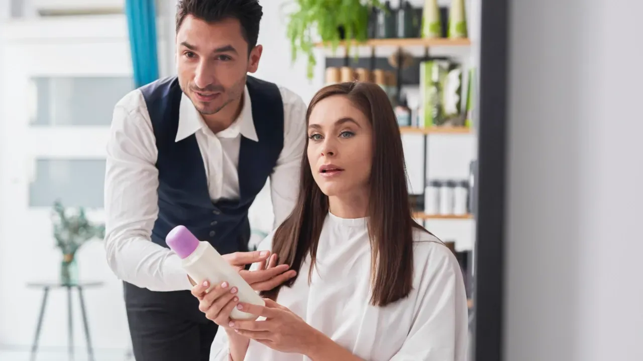 young stylist giving advice to a customer about a product