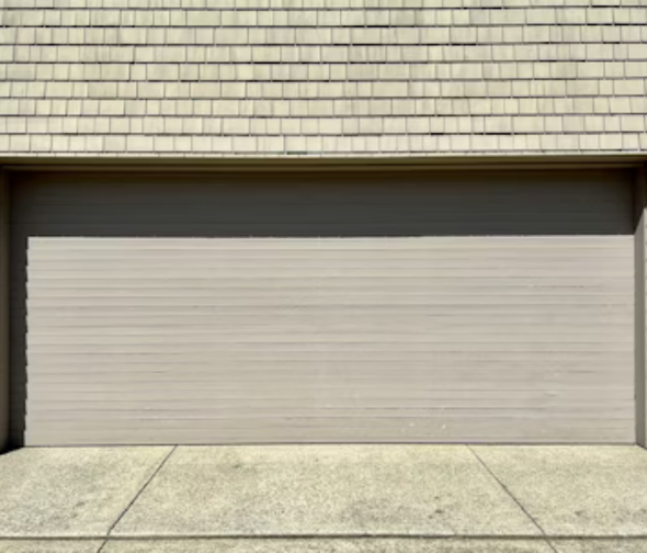 Beige sectional garage door installed on a Sydney home