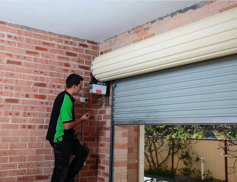 Technician repairing a garage door in Killara