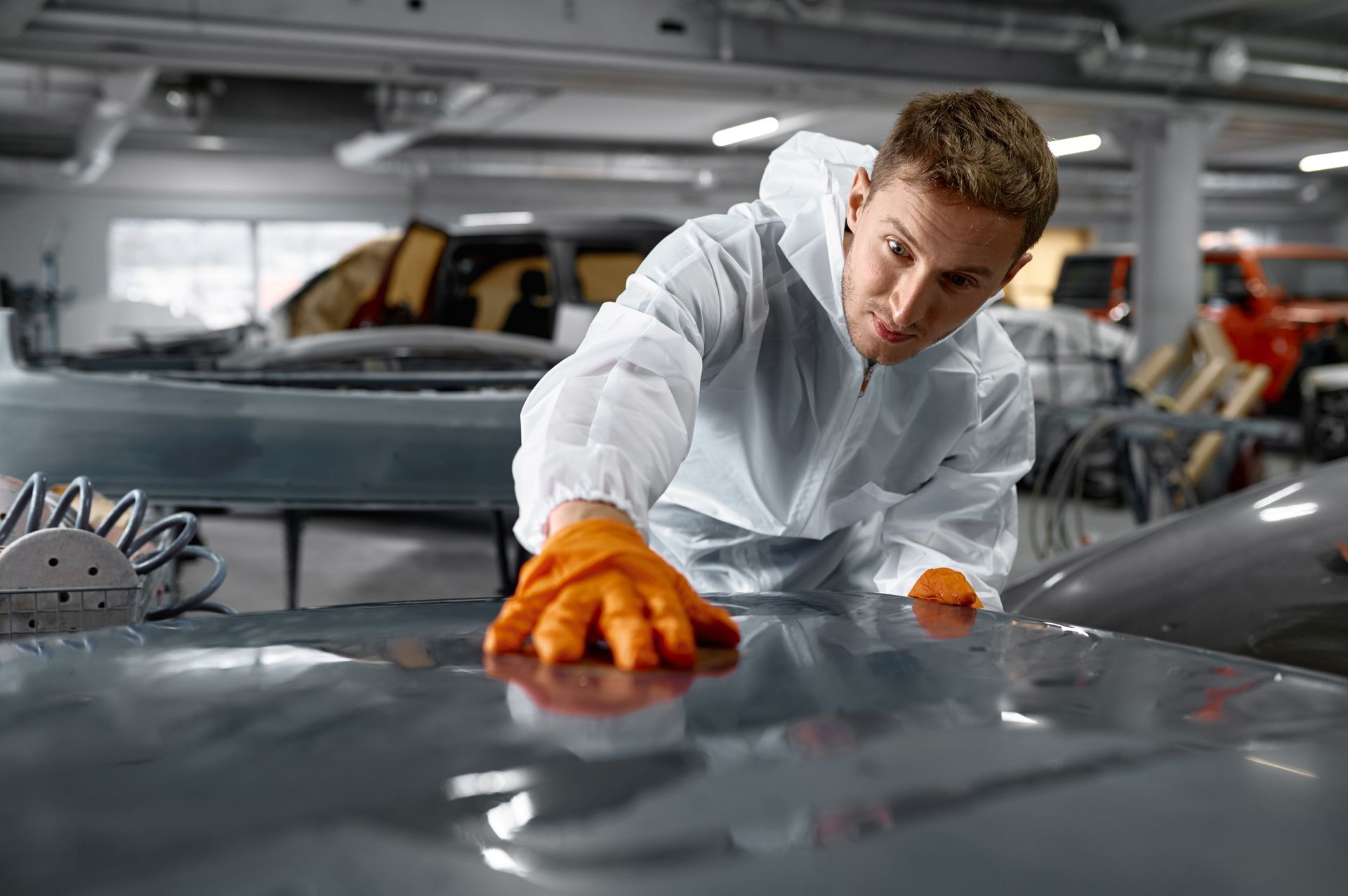 Auto body professional assessing paint and body damage before auto body repair