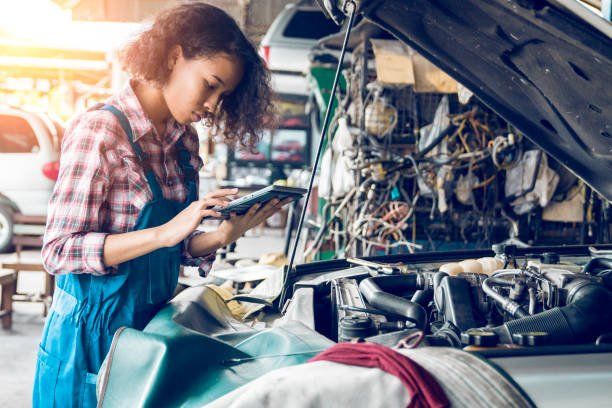 Female Auto Mechanic Is Working In A Car Repair Shop Female Auto Mechanic Is Working In A Car Repair Shop