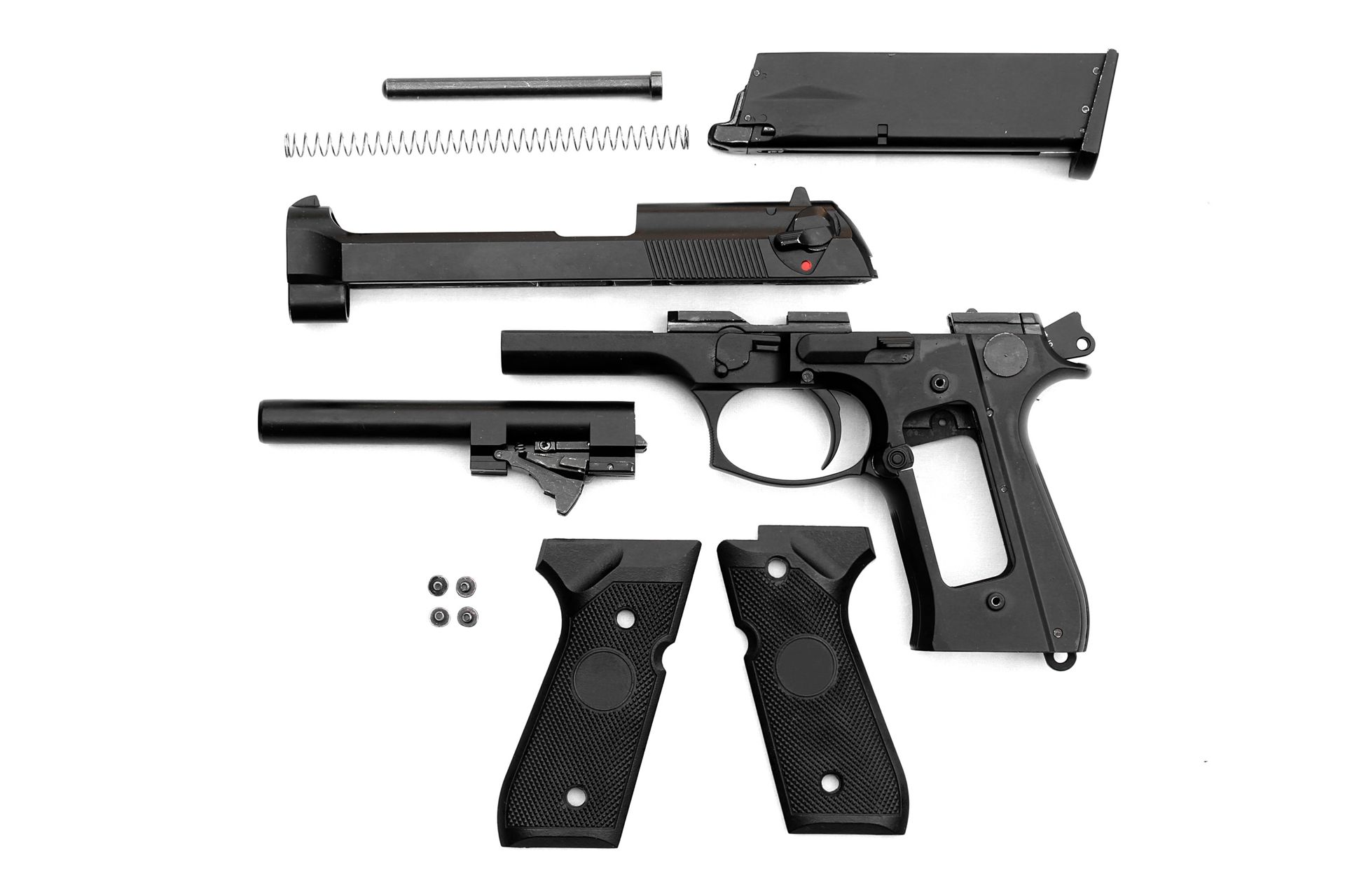 Disassembled handgun on white background. Disassembled handgun on white background.