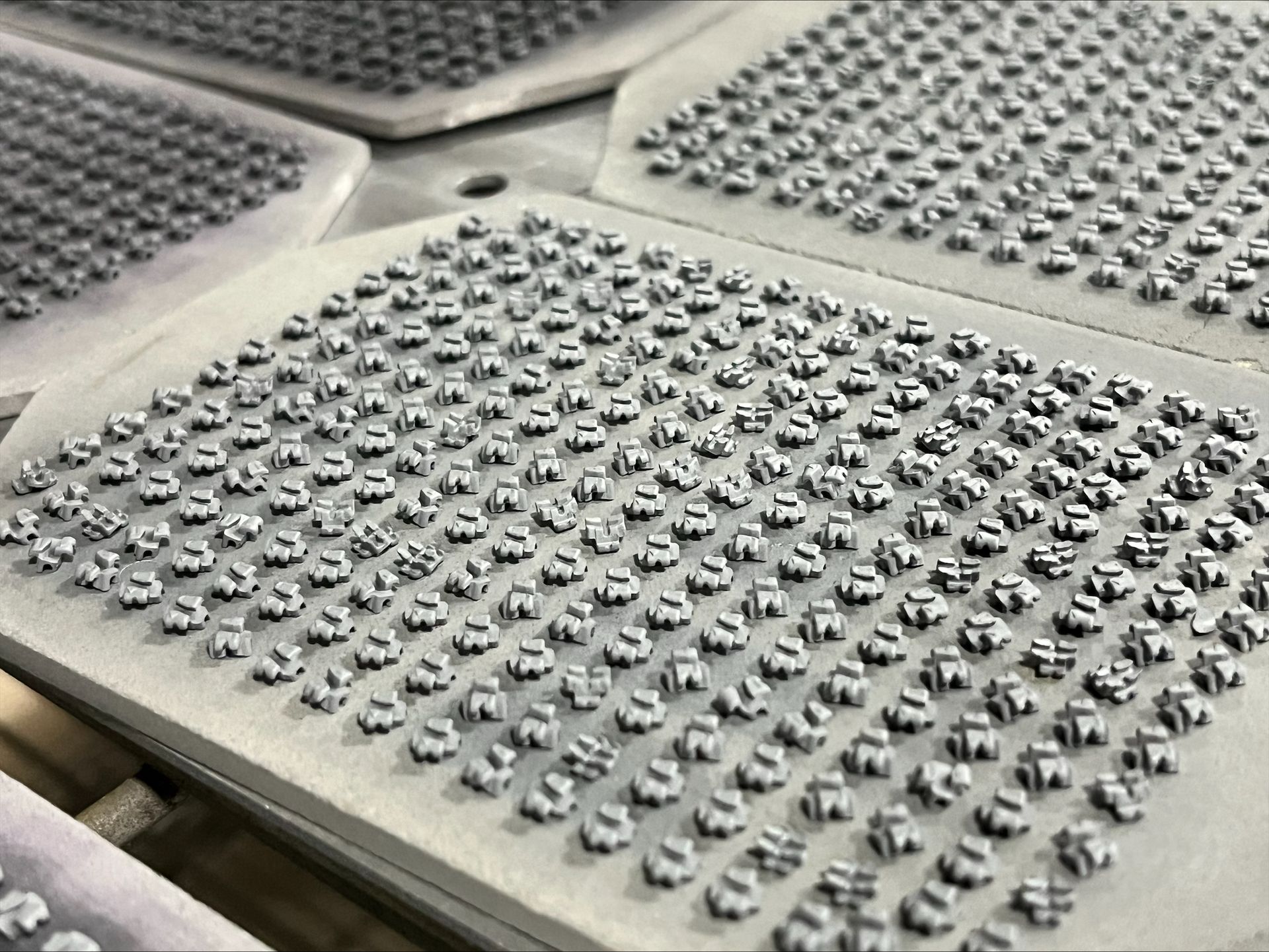 Precision machined metal mold plate with circular cutouts and polished industrial detailing. Precision machined metal mold plate with circular cutouts and polished industrial detailing.