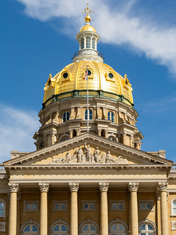 Gold-domed neoclassical capitol building against a blue sky