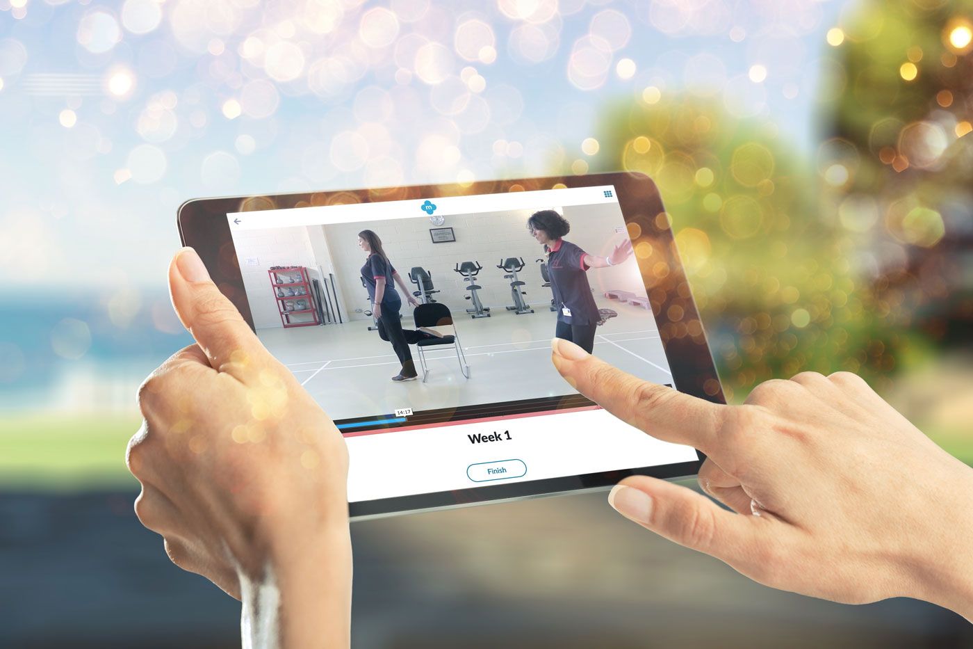 A person is holding a tablet with a video on it.