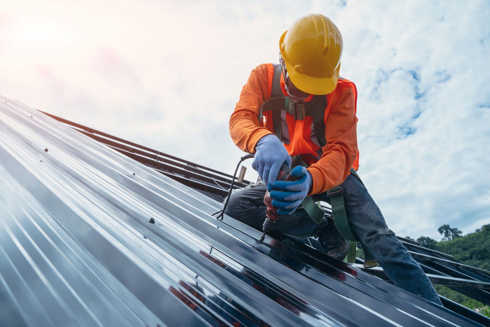 Roofer worker in special protective work wear and gloves — Bossier City, LA — Cochran Construction Company Roofer worker in special protective work wear and gloves — Bossier City, LA — Cochran Construction Company