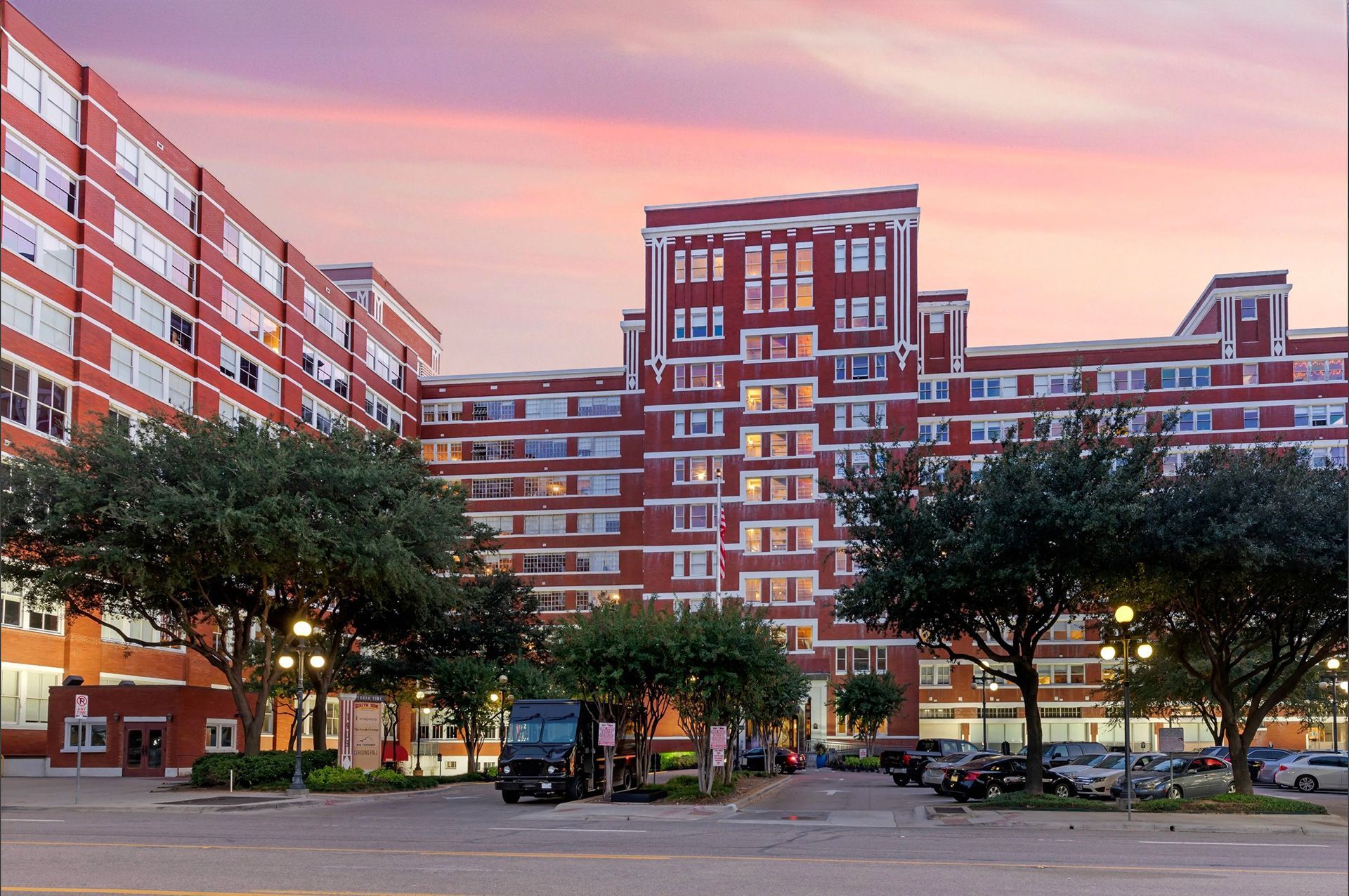 A large brick building with cars parked in front of it