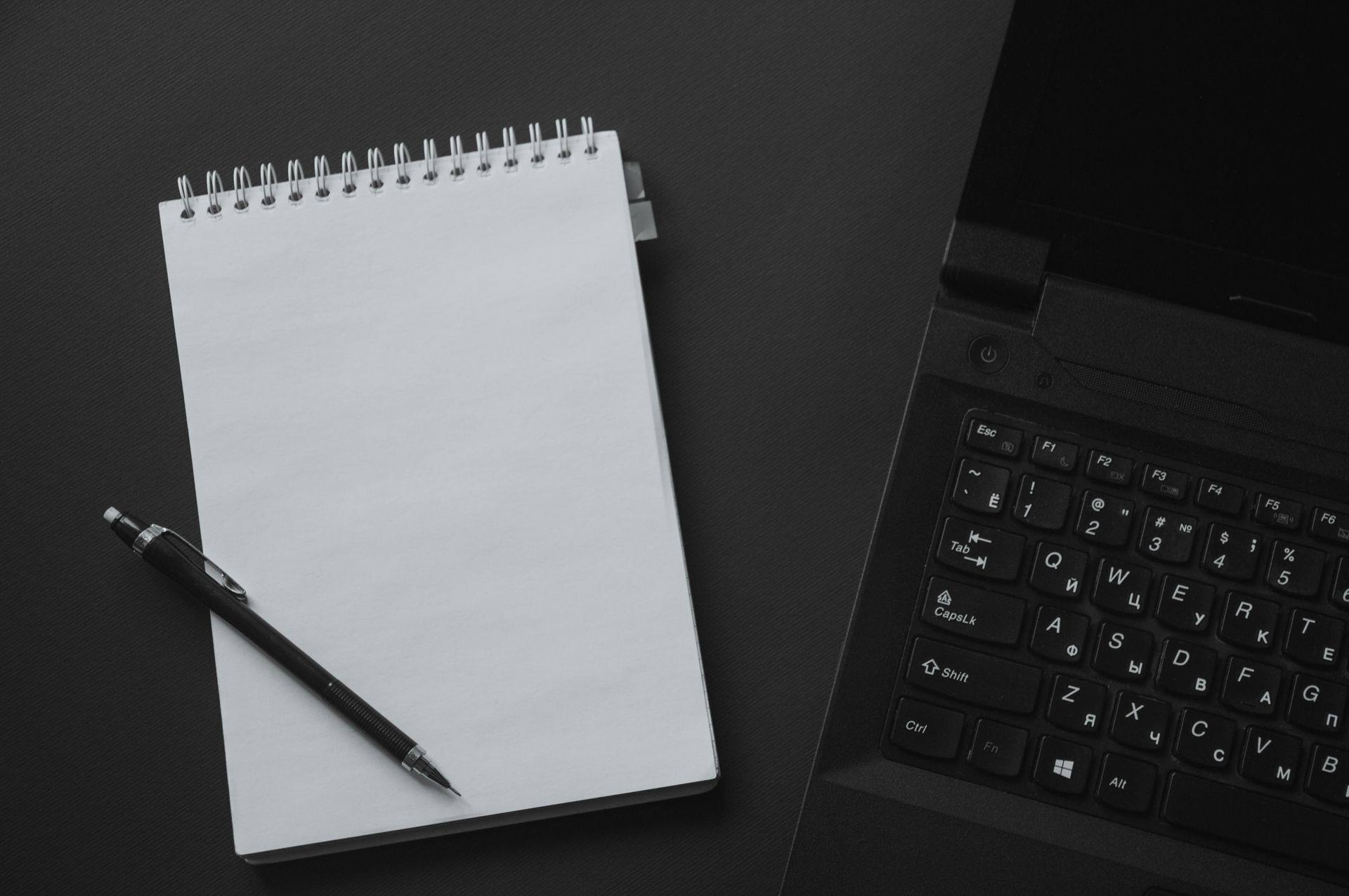 Notebook and laptop on desk – business strategy and decision making