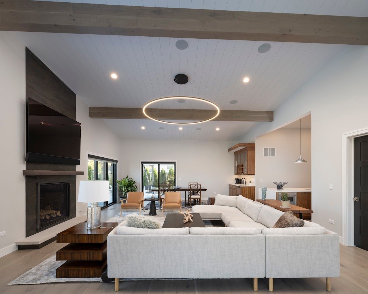 A living room with a white couch and a fireplace