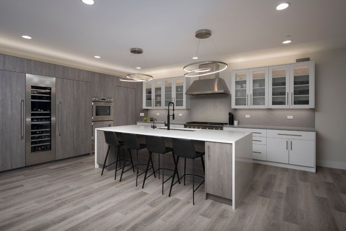 A kitchen with a large island and stools